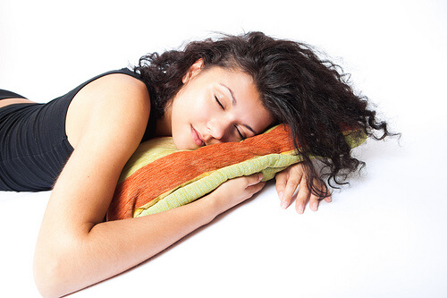 woman sleeping on a multicoloured pillow