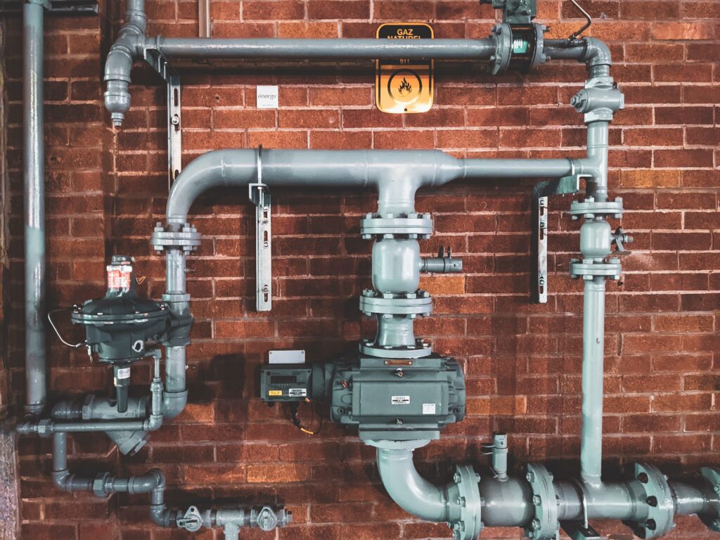 image of a plumbing system in front of bricks